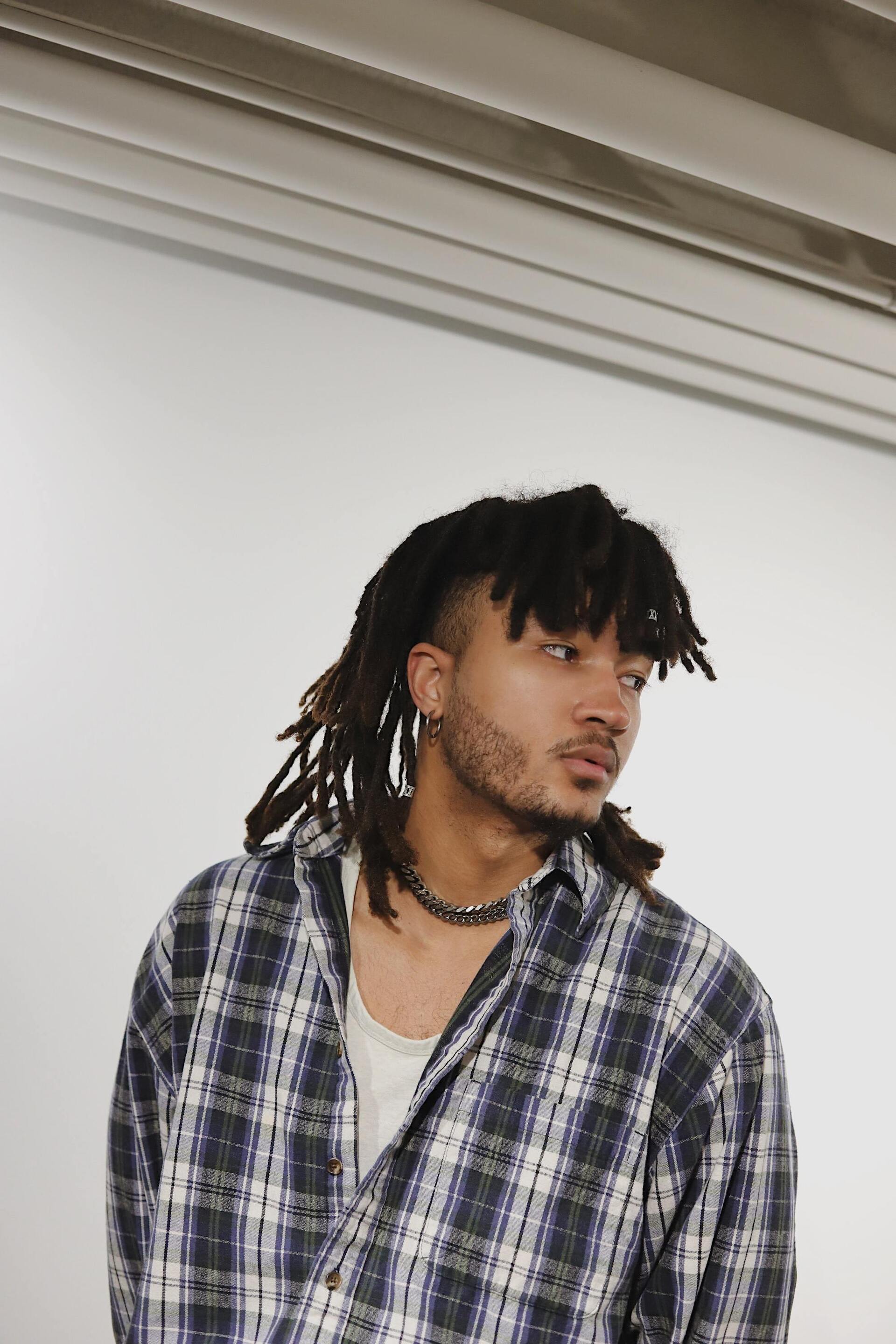 man with locs hairstyle and an undercut