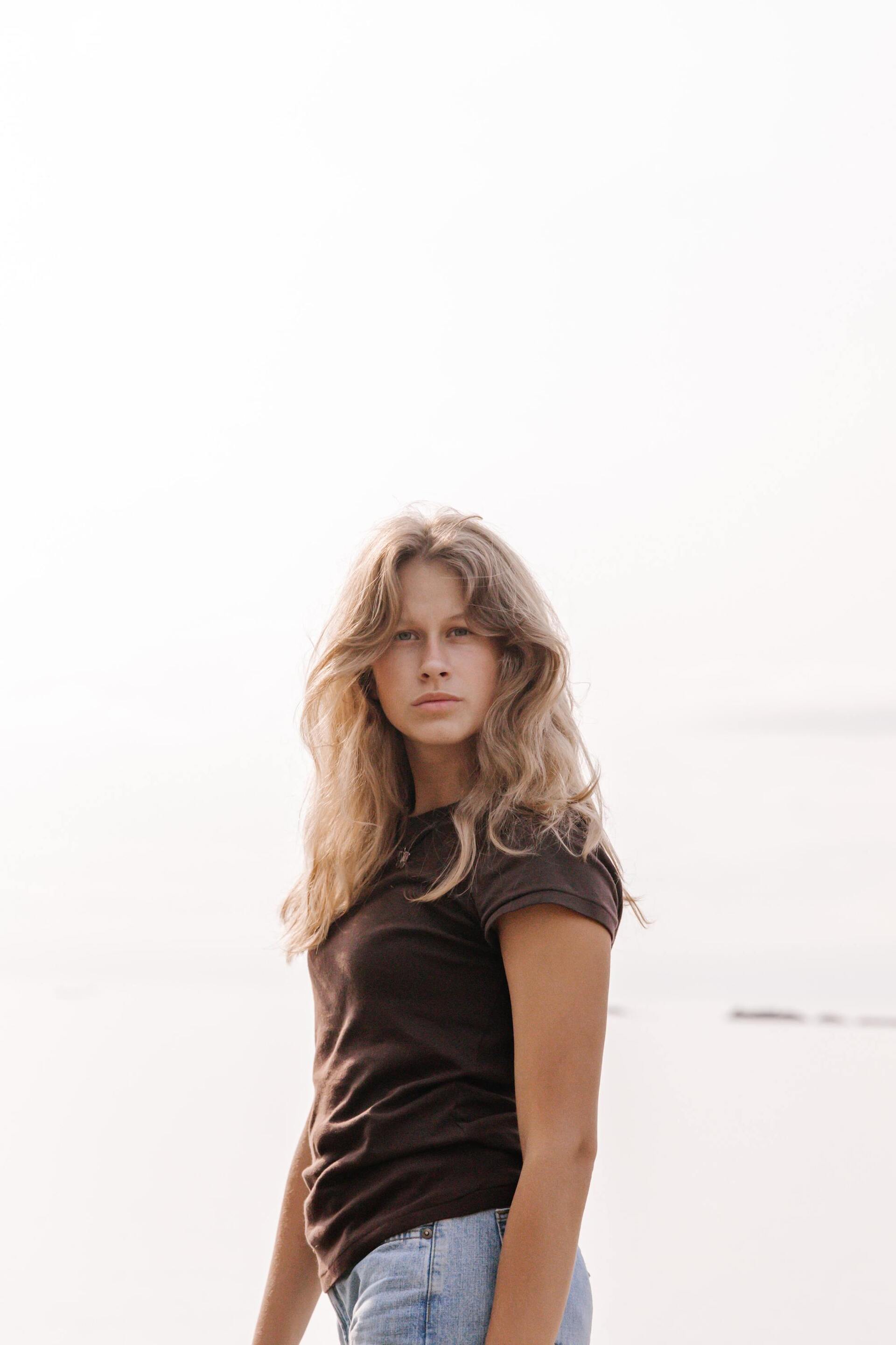 2022 hair trends: woman with long dark blonde wavy hair with a long wavy fringe and middle path