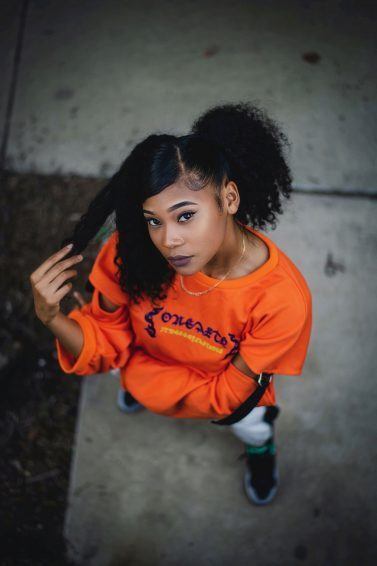 woman with curly hair and sleek baby hairs