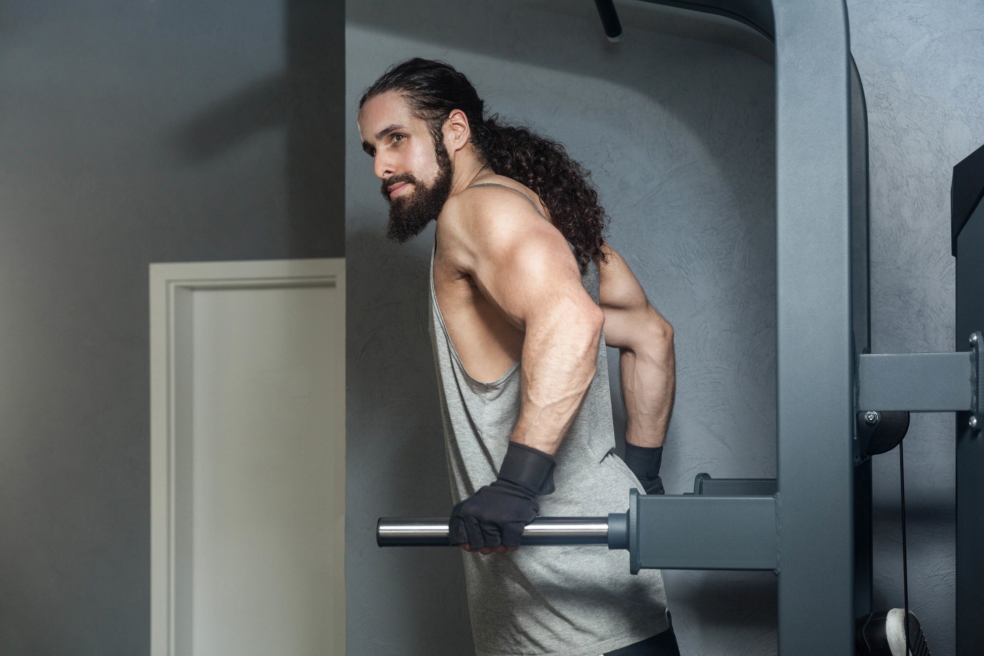 Man with long ponytail working out at gym