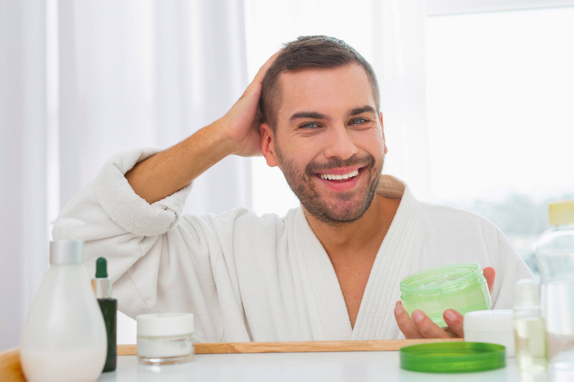 Man applying gel to his hair
