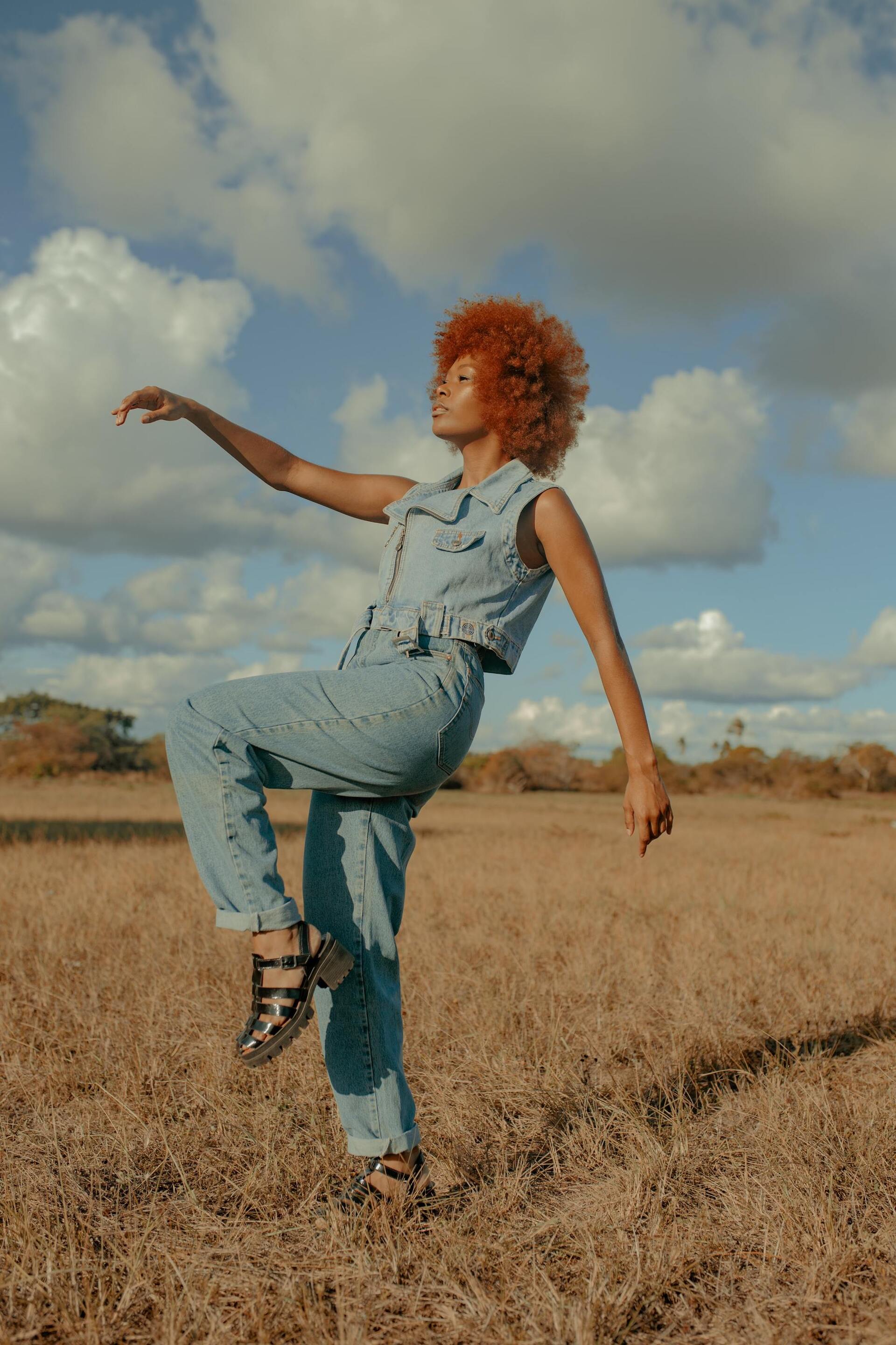 Woman with an orange coloured stretched afro