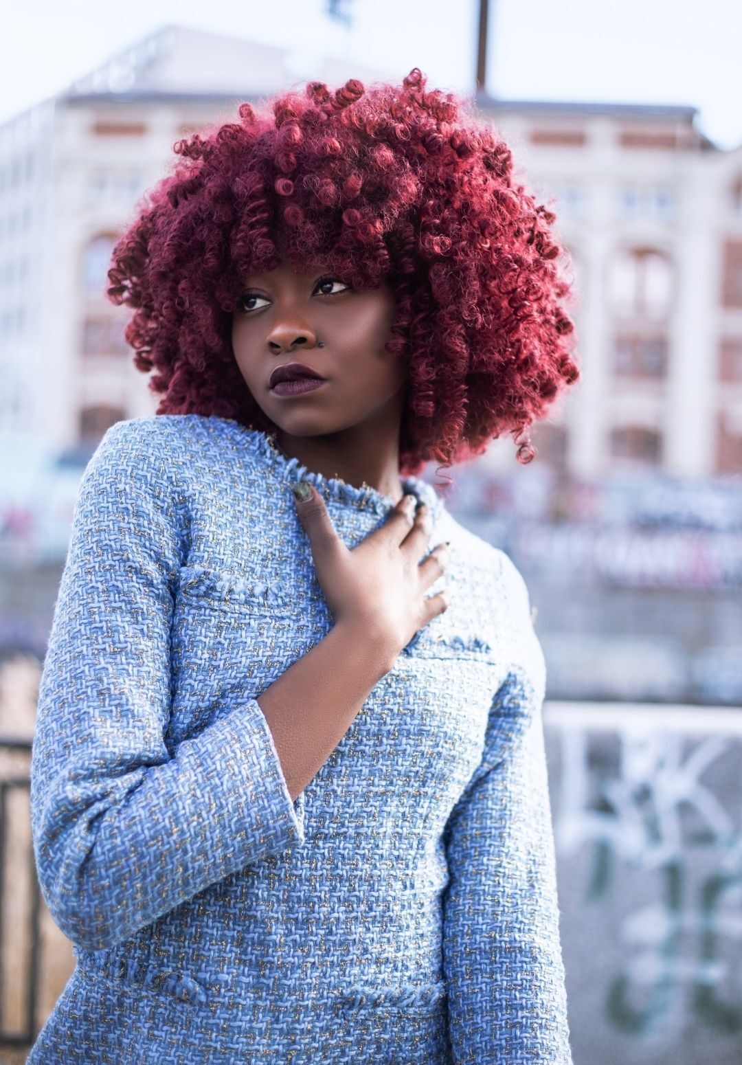 2022 hair trends: woman with a bright red afro