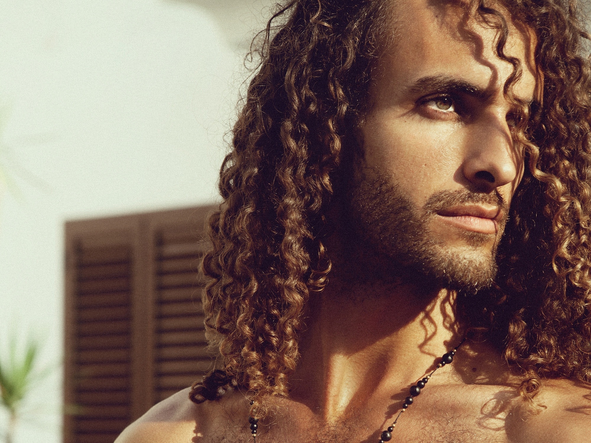 man with long defined curly hair