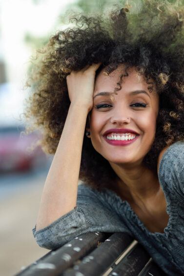 woman with natural curly hair afro and blonde highlights