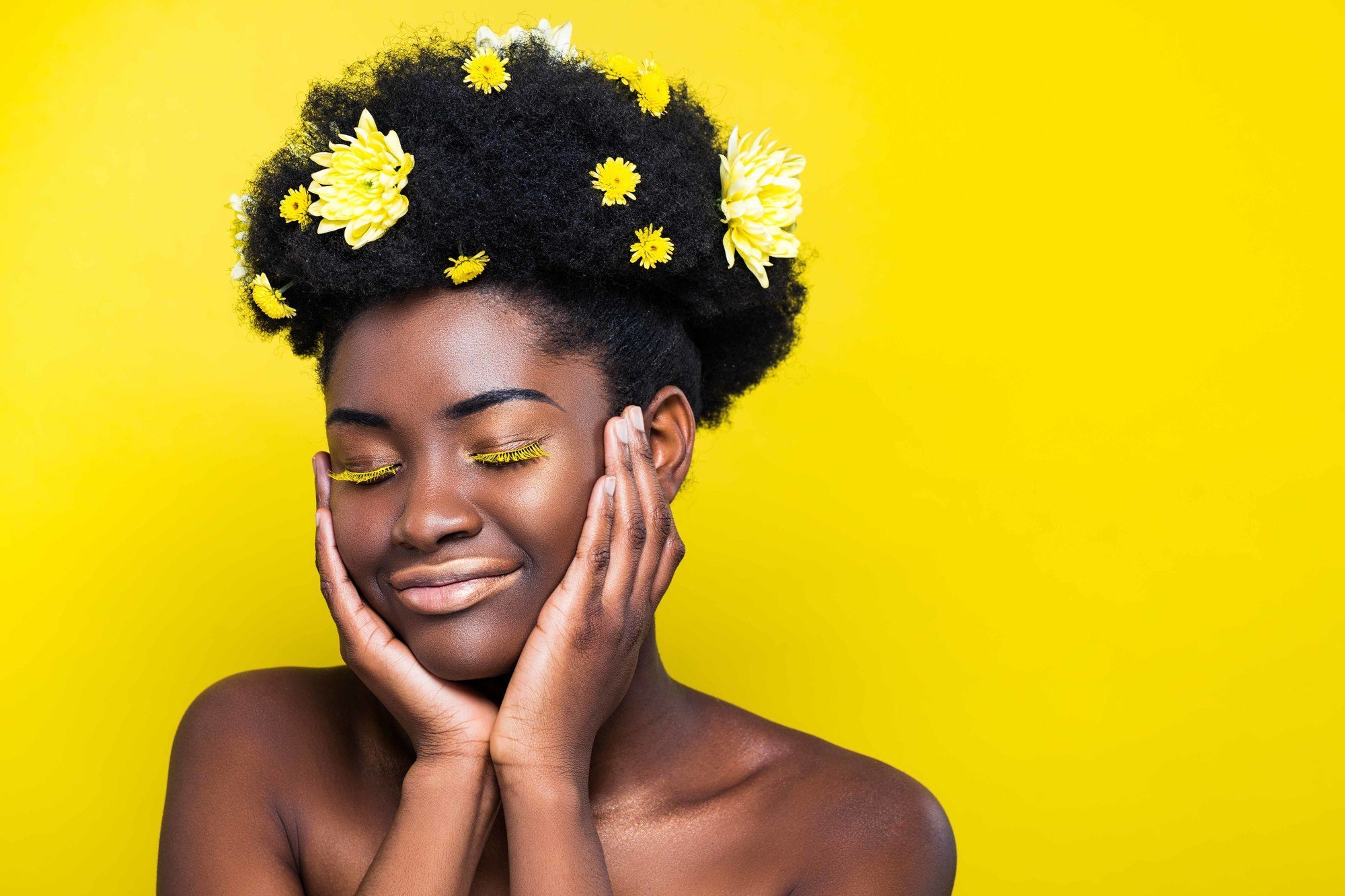 woman with afro and yellow flower accessories