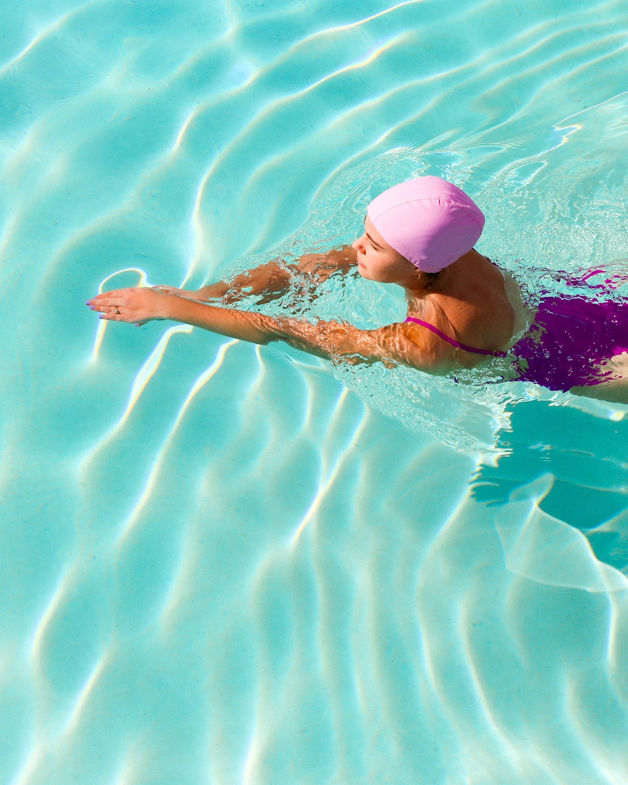 Woman in the pool wearing a swimming cap