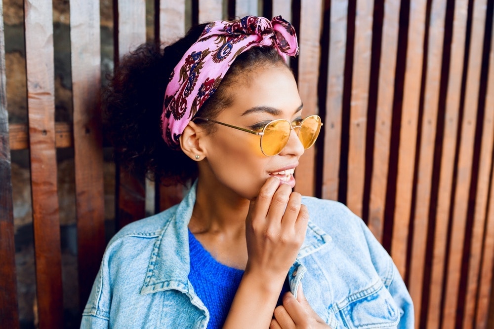 woman with a pink headband and natural curly hair