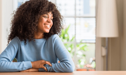 Happy, radiant woman who has discovered the benefit of vitamin E
