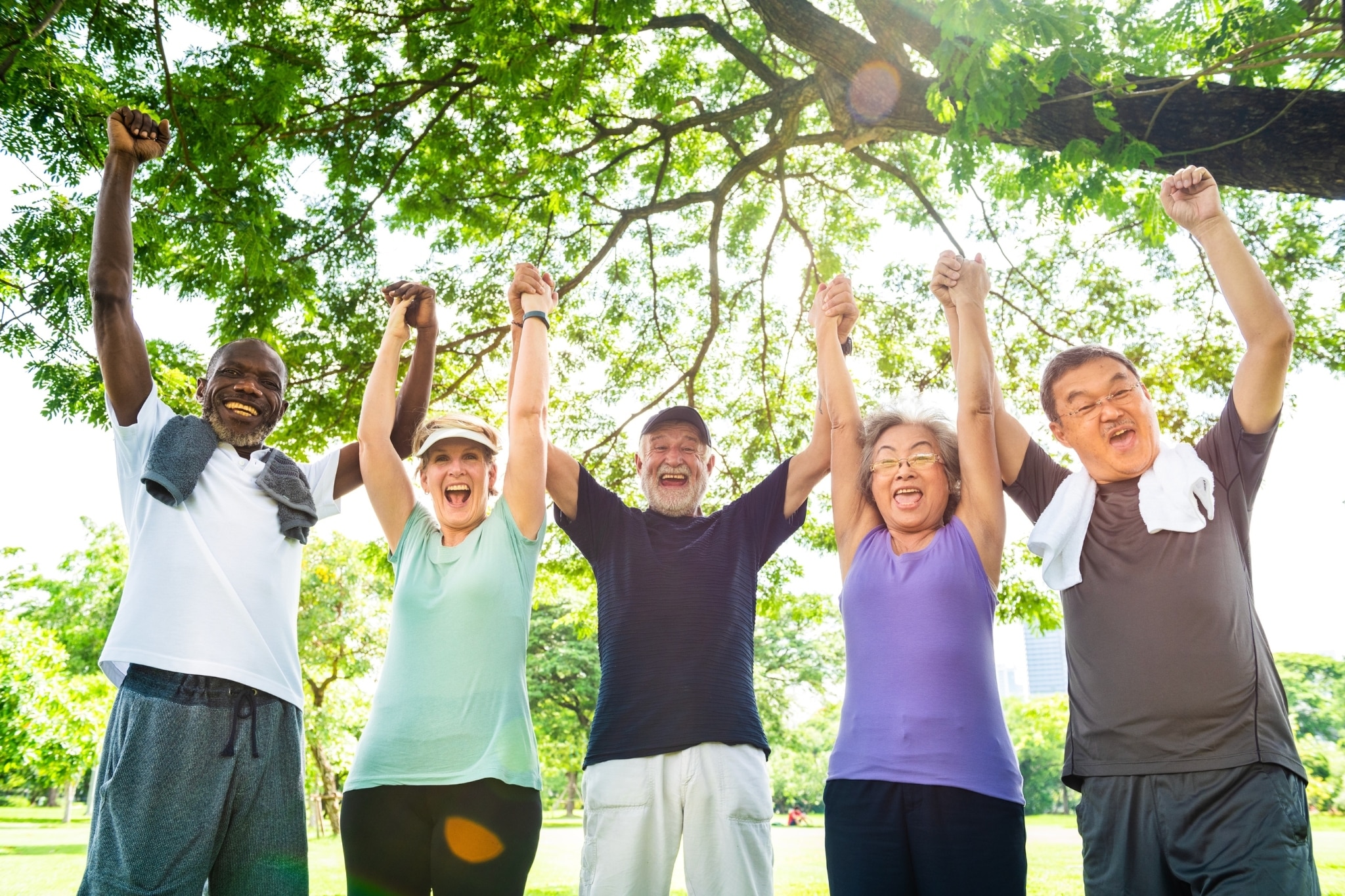 Diverse group of older friends raising their arms and hands with no smelly armpits