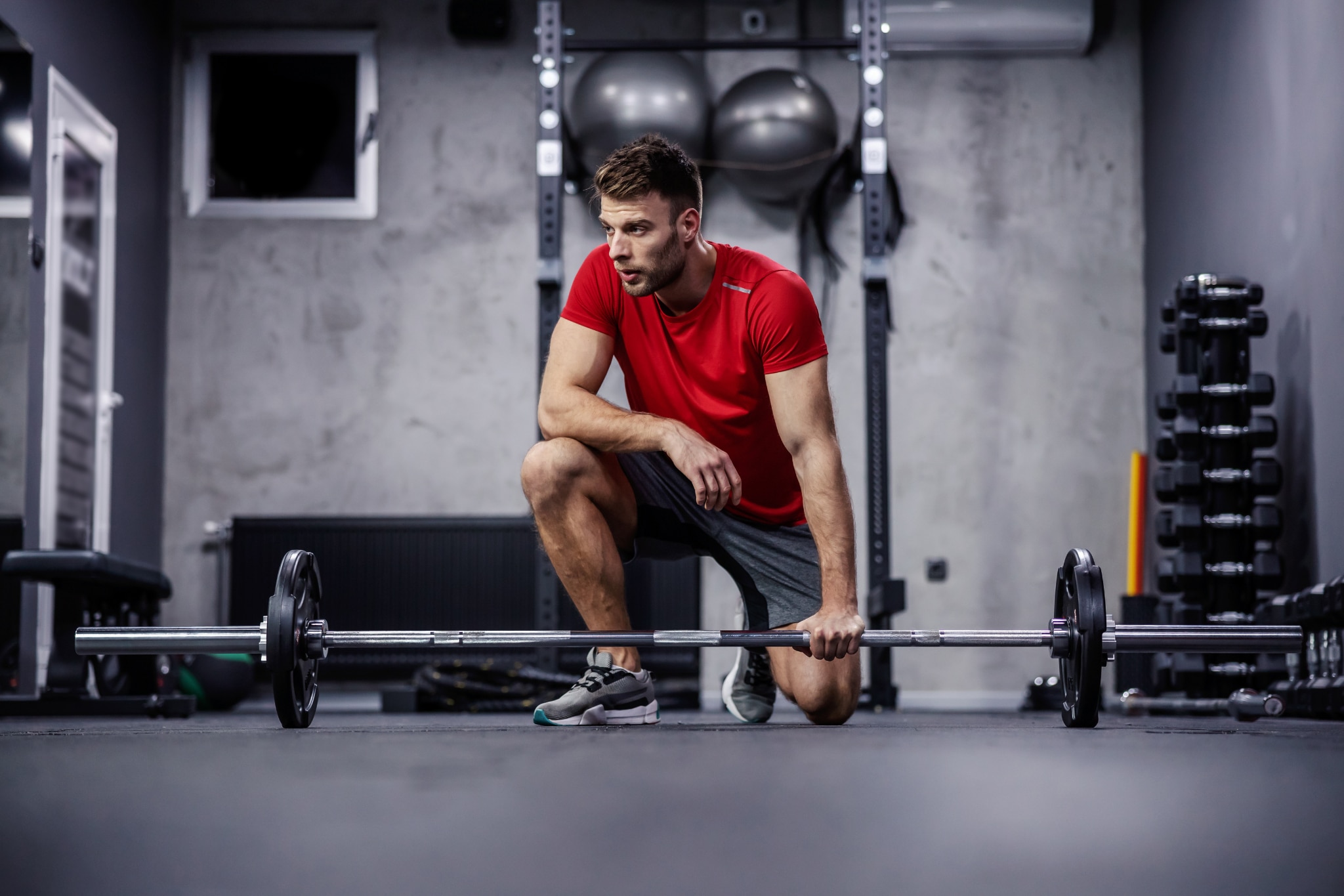 Man at the gym working out in loose fitting shorts with no sign of groin sweat