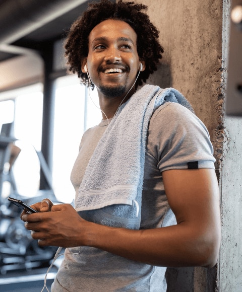 Young man with towel wrapped around him taking an exercise break