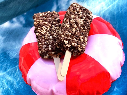 Chocolate Èclair Bars resting on a colorful float on a pool background