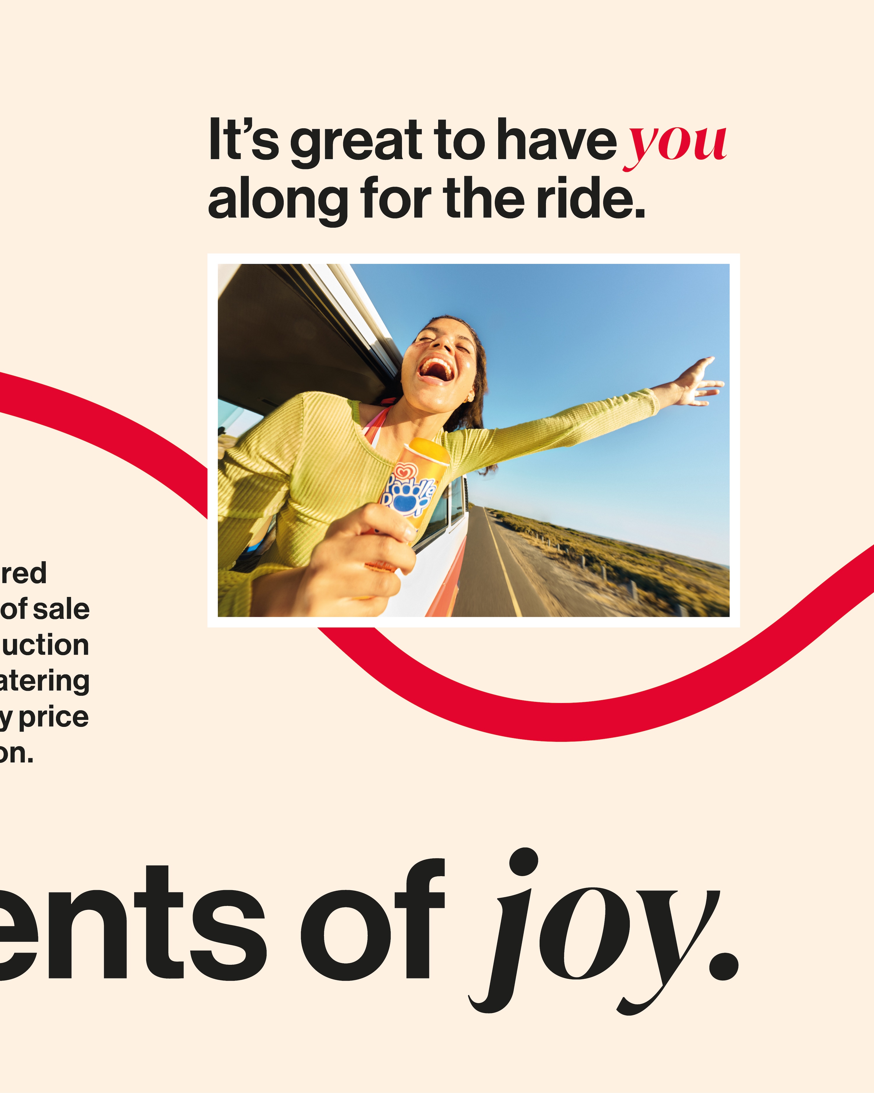 Woman with arms outstretched enjoying a car ride while holding an ice cream