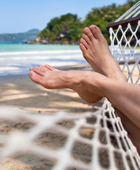 Young woman with bare feet enjoying a day at the beach