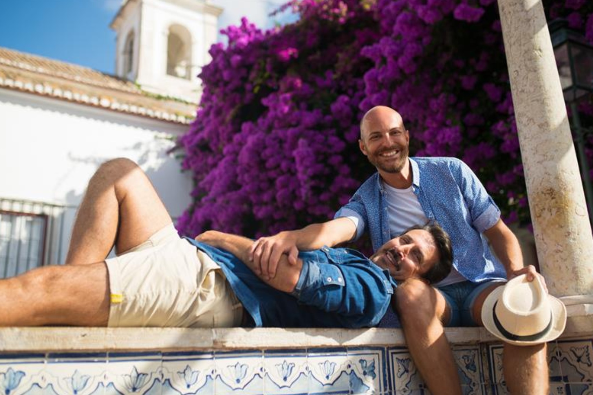 Happy male couple relaxing on vacation smelling fresh from deodorant