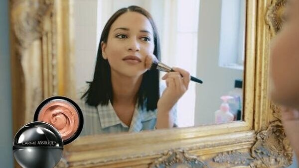 Concealer or Foundation? What is the Difference? woman dark skin brush