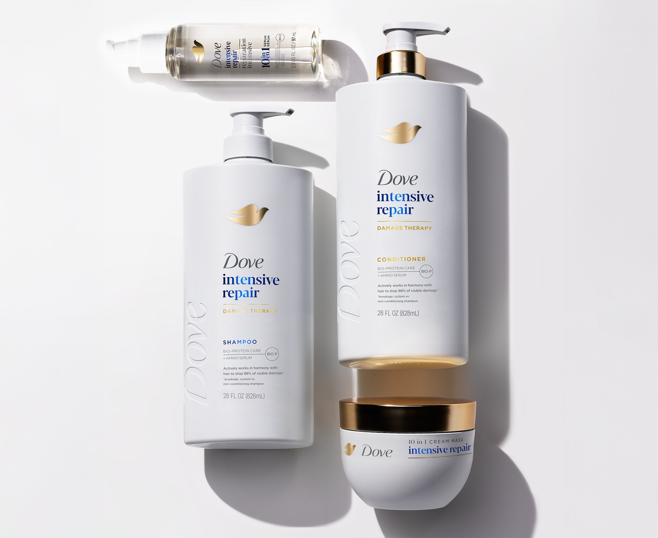 Dove Intensive Repair Shampoo, Conditioner, Hair Mask and Hair Serum laying flat against a white background