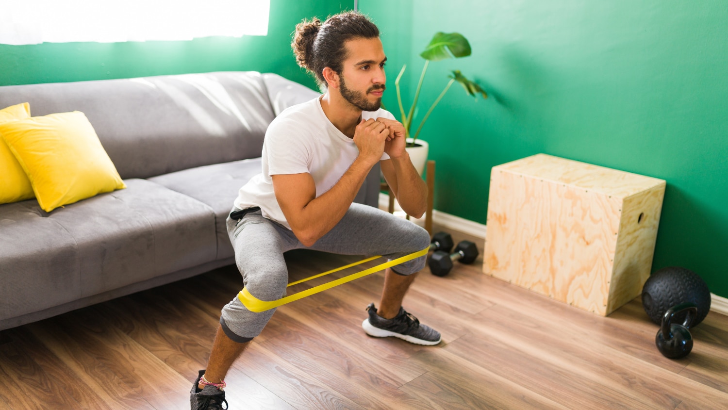 Young man doing a workout with resistance bands without breaking a sweat