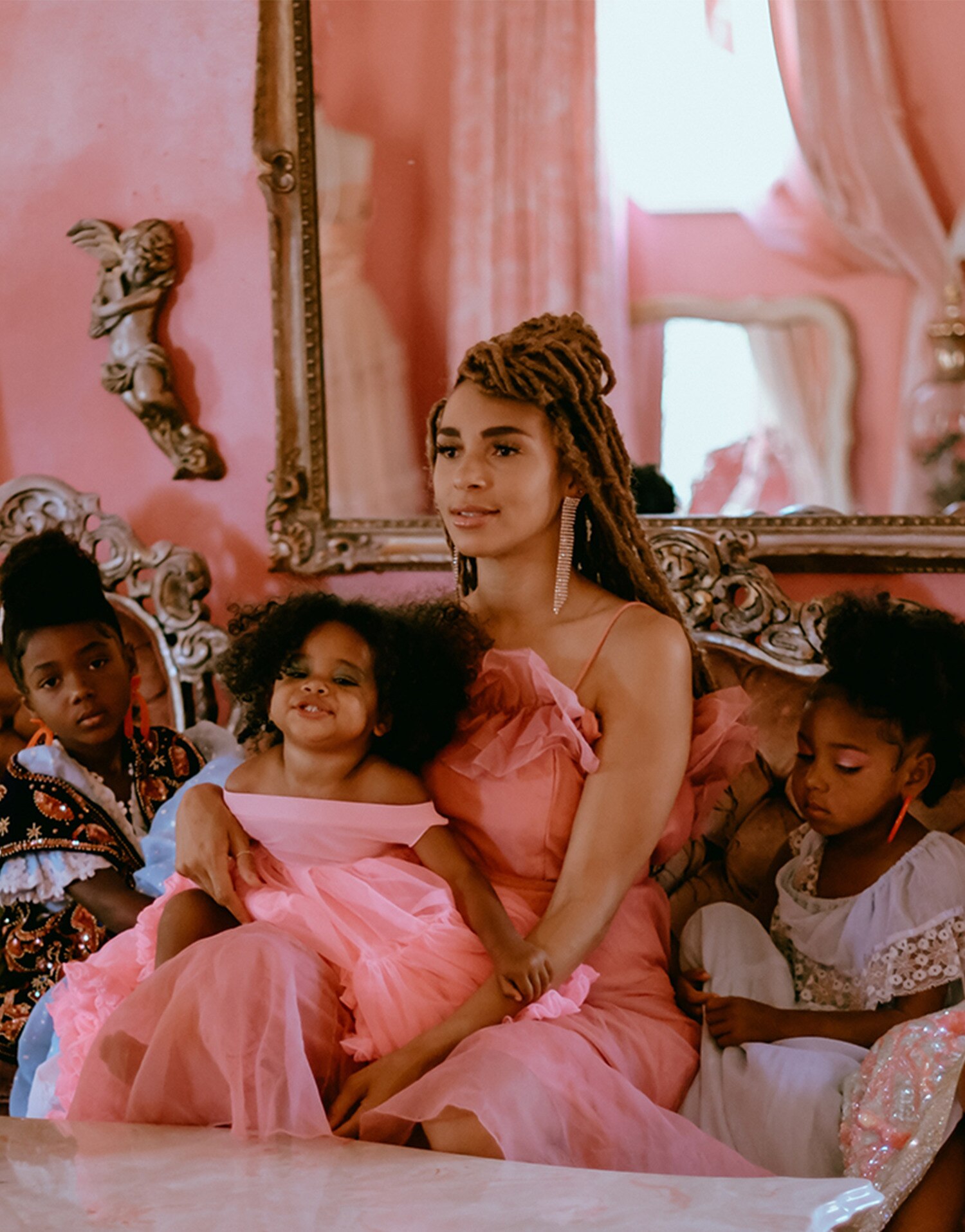 Woman sitting on the sofa with her three children