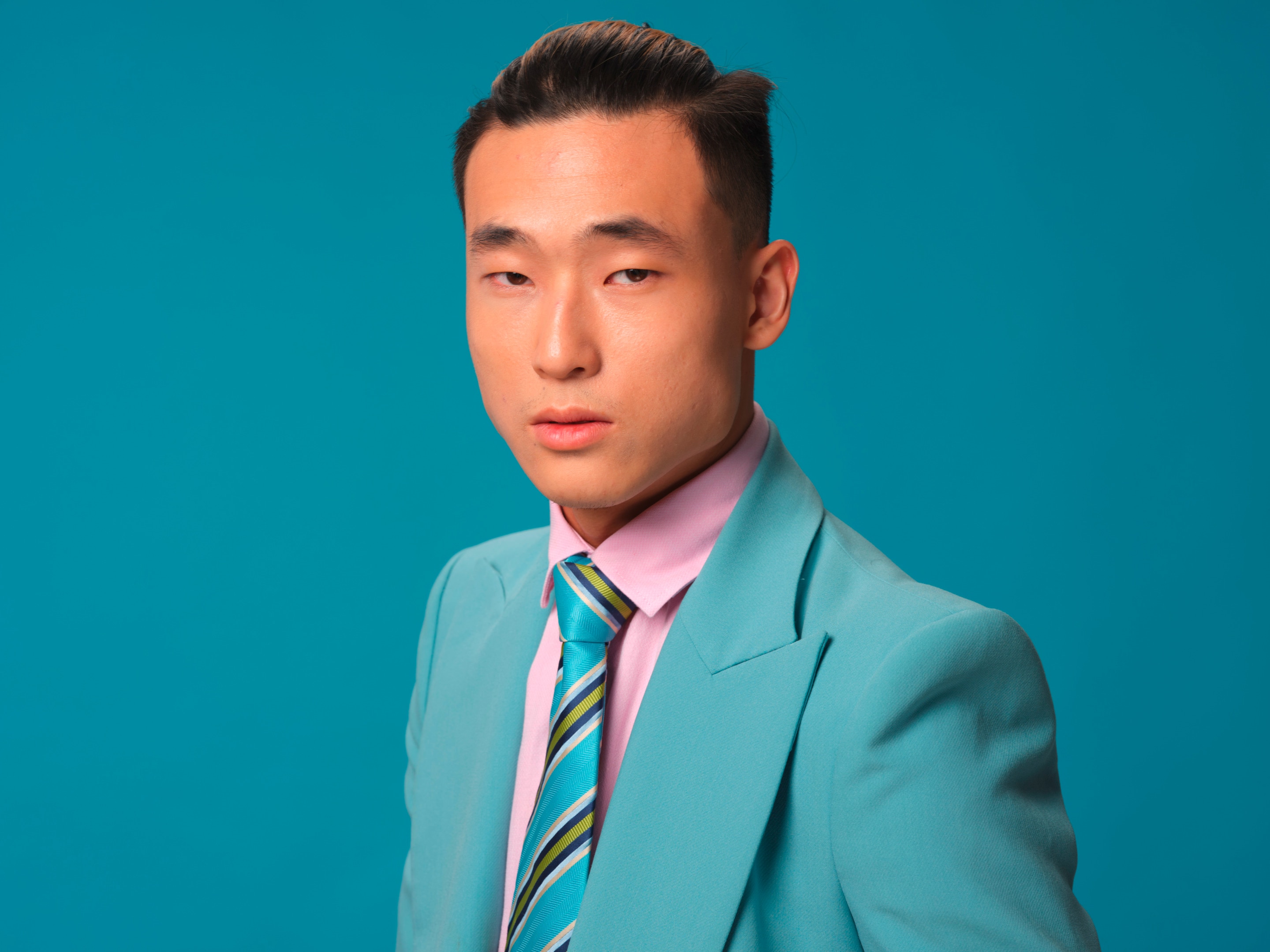 Man with slicked-back hair.