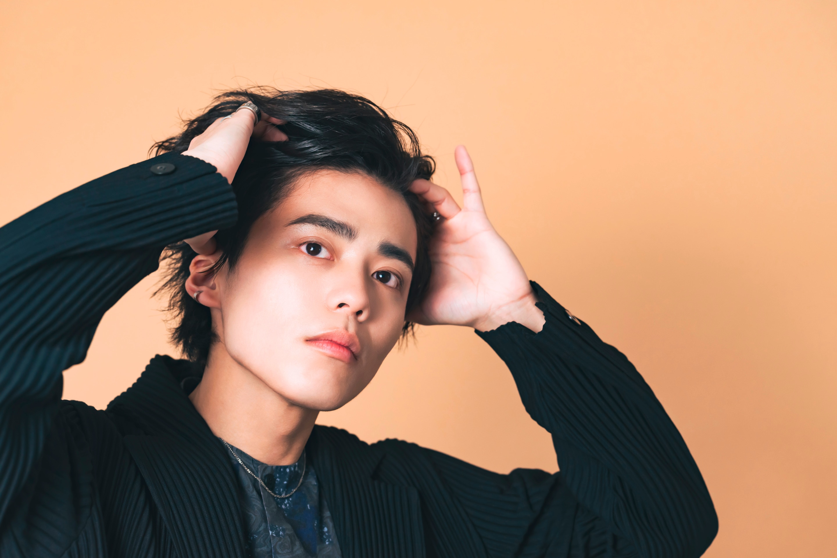 Man combing through his hair with fingers.