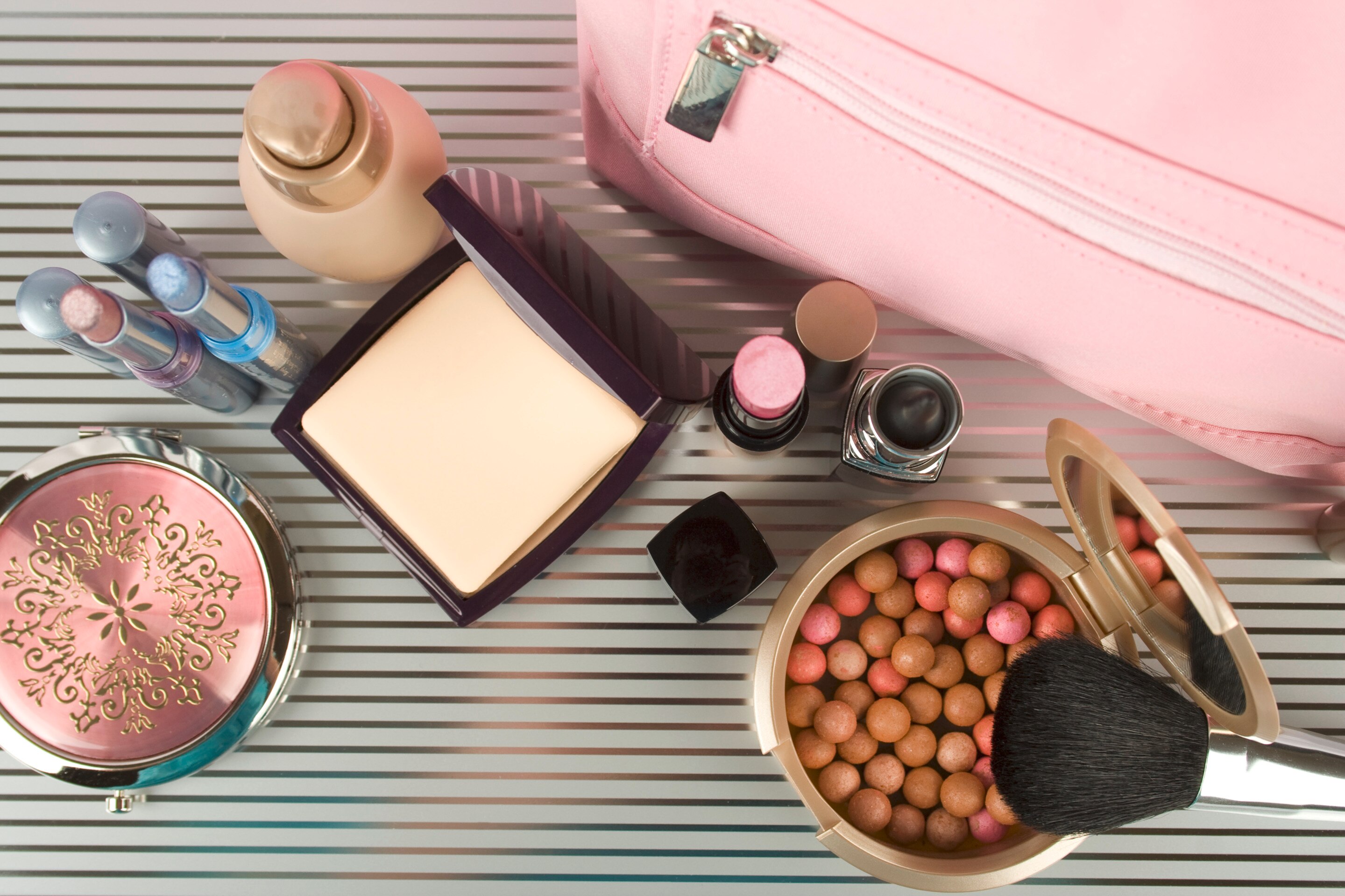 A table with an assortment of makeup products.
