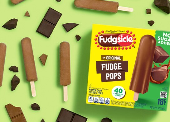 Fudgesicle on green background with chocolate pieces