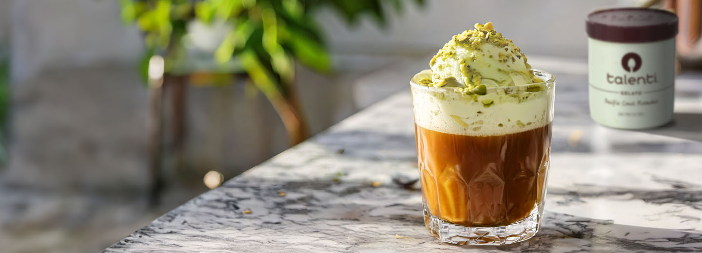 Glass of pistachio affogato with a pint of Talenti Pacific Coast Pistachio Gelato in the background