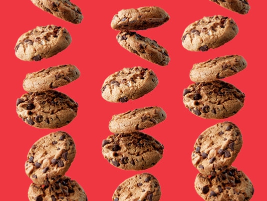 Chocolate chip cookies on red background.