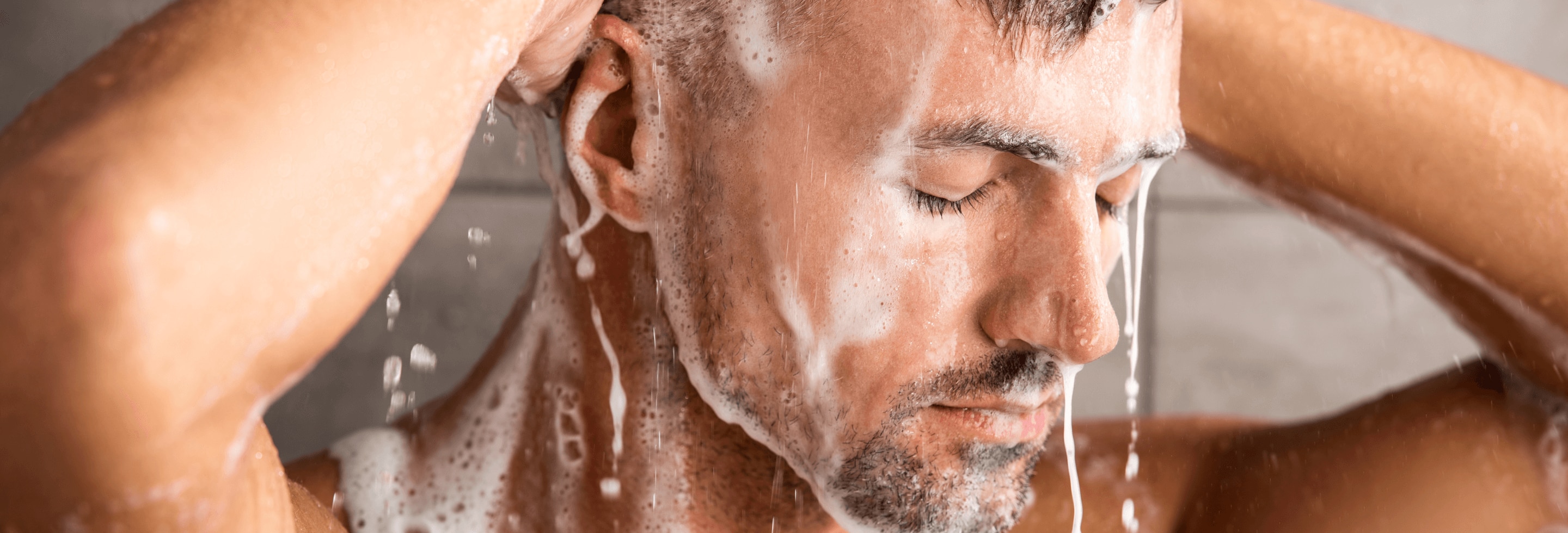 Man in shower using a body wash that hasn’t expired.