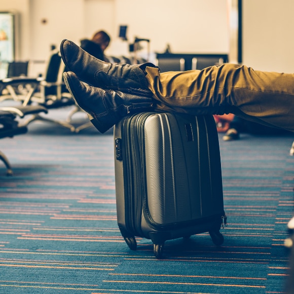 Man with his carry-on luggage and TSA-approved, packed bar of soap