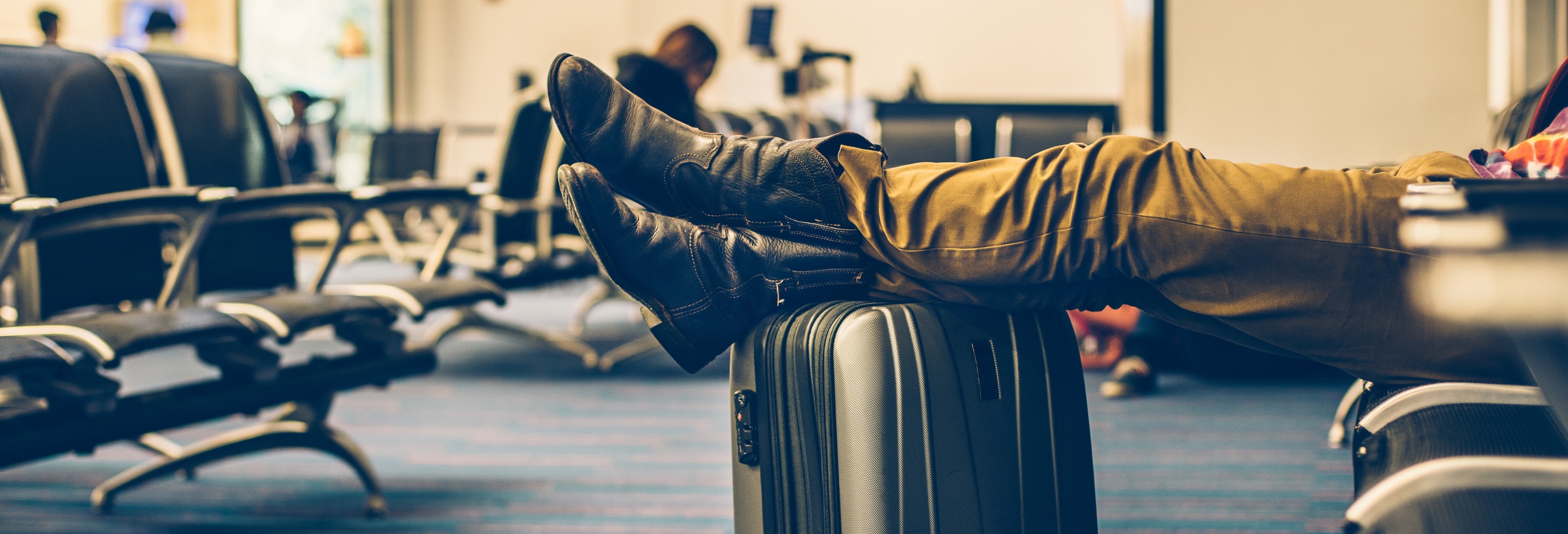 Man with his carry-on luggage and TSA-approved, packed bar of soap