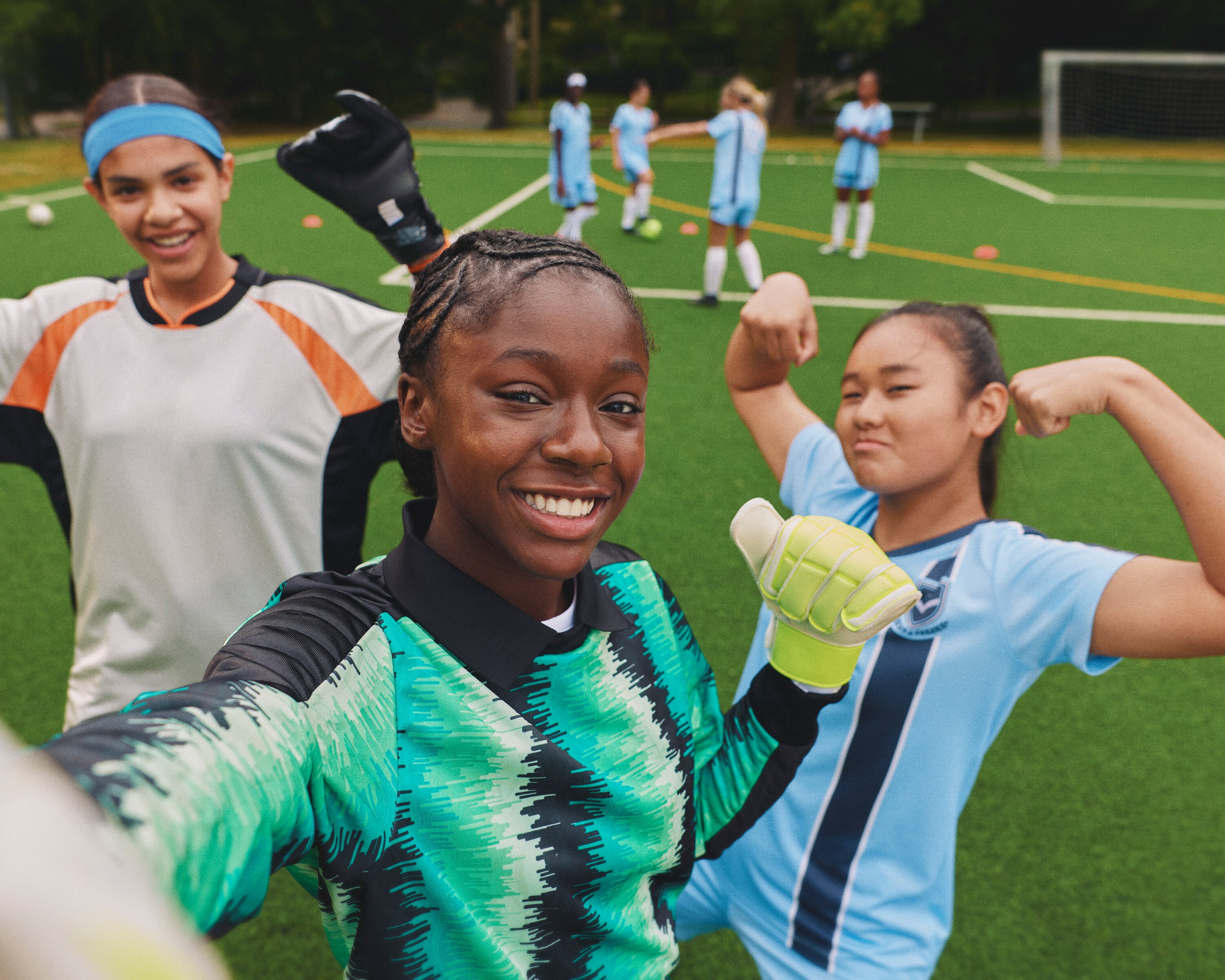 Image of three girls training on a football pitch
