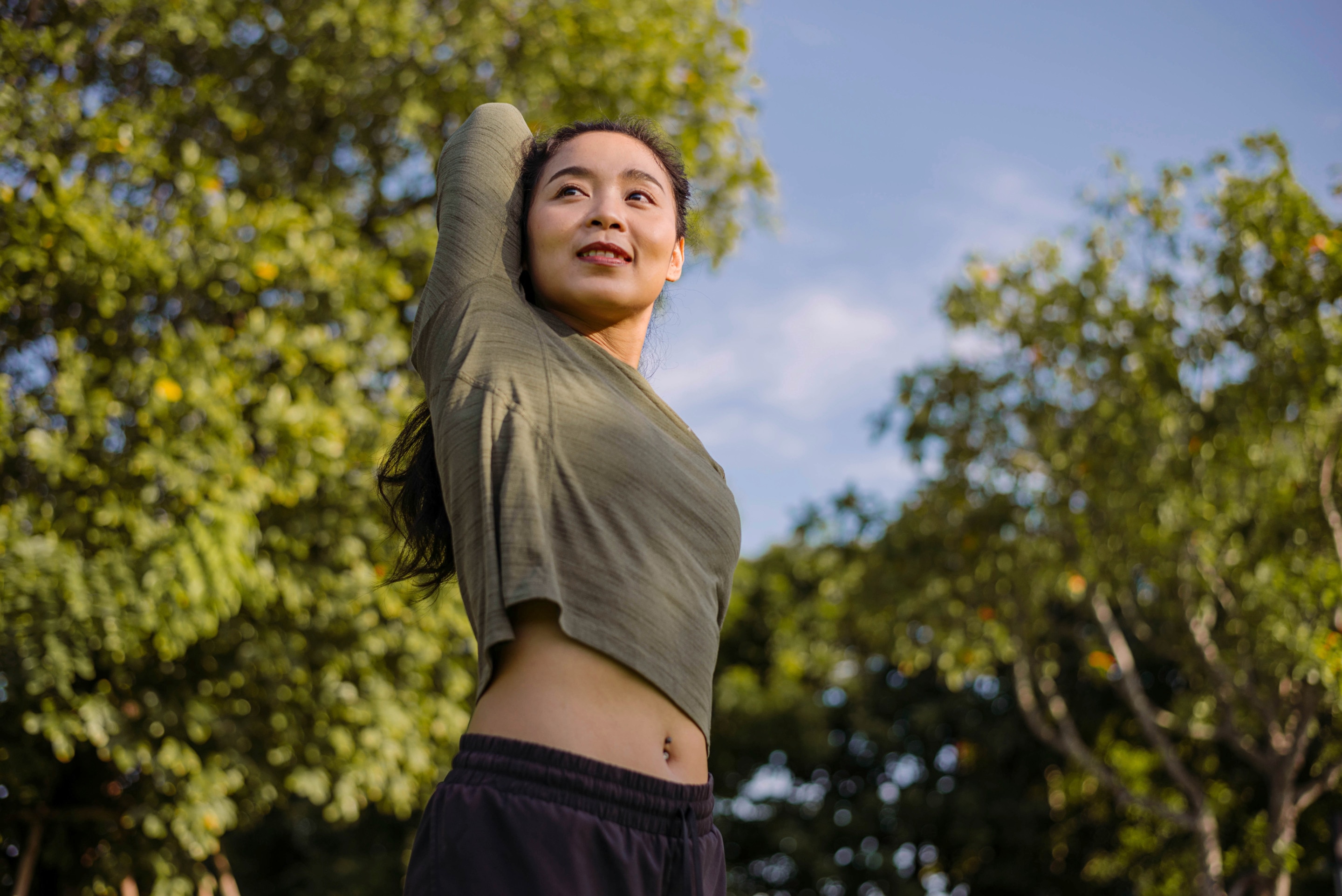 Woman stretching her arms outdoors.