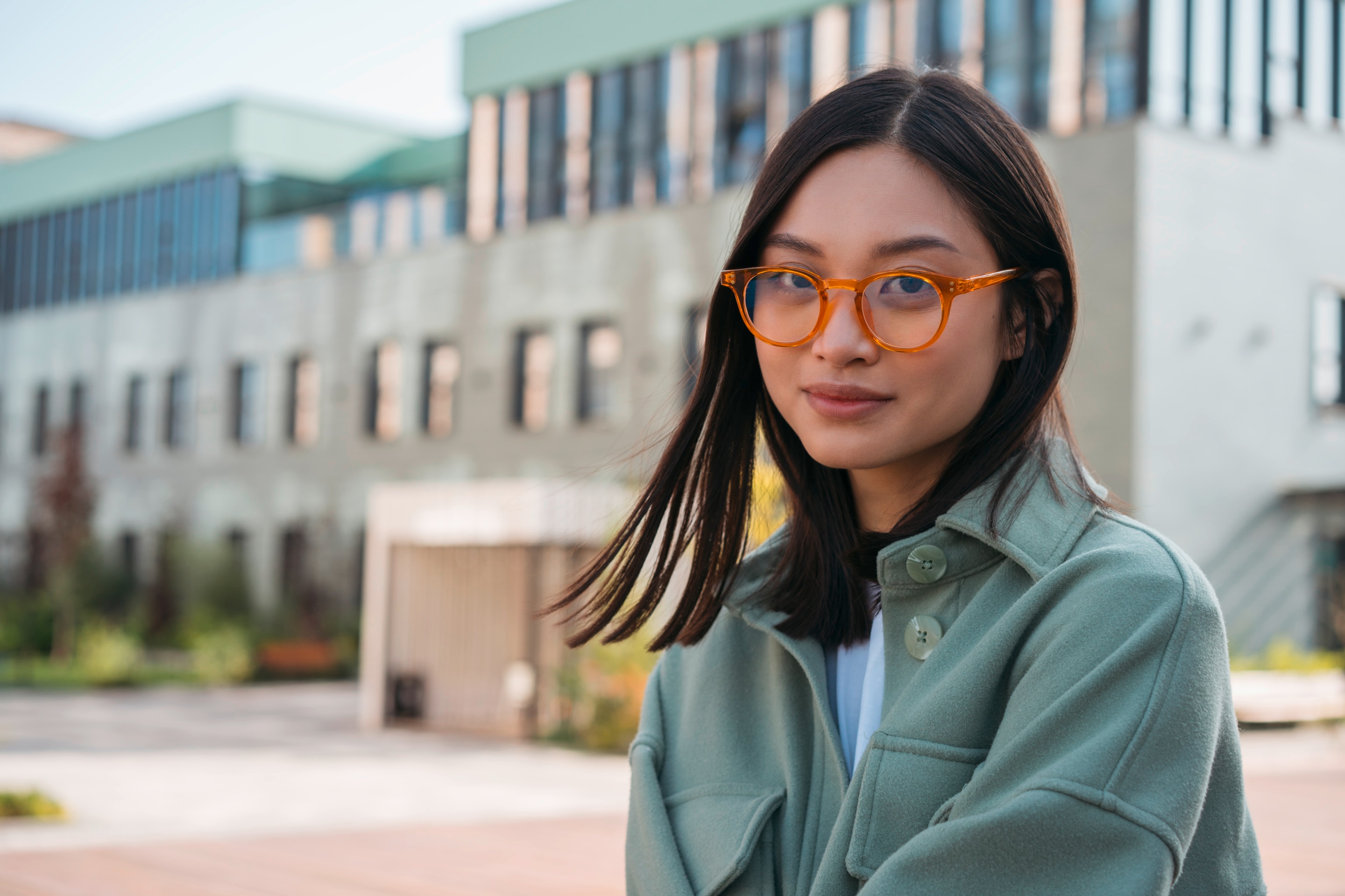 Woman wearing yellow-framed glasses.