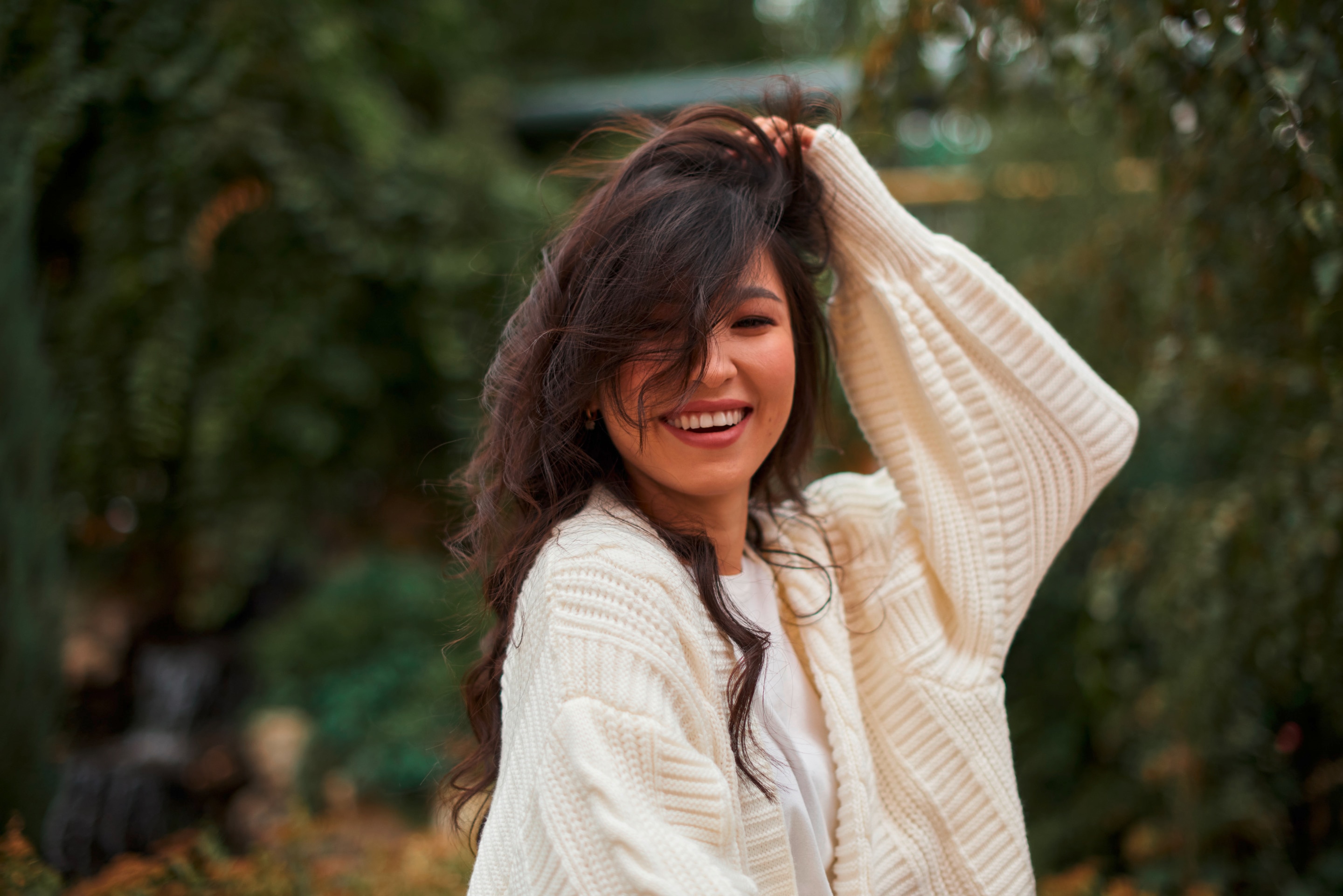 Asian woman with long hair and soft curls.