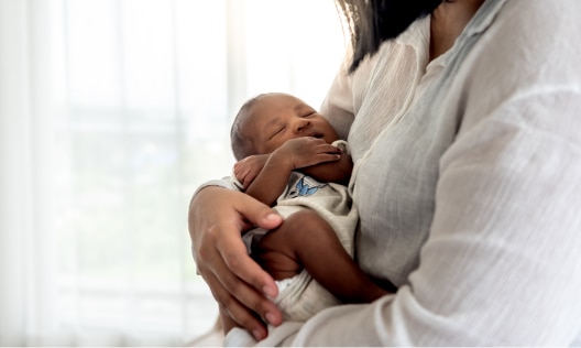 Woman holding her baby without any worries about postpartum body odor