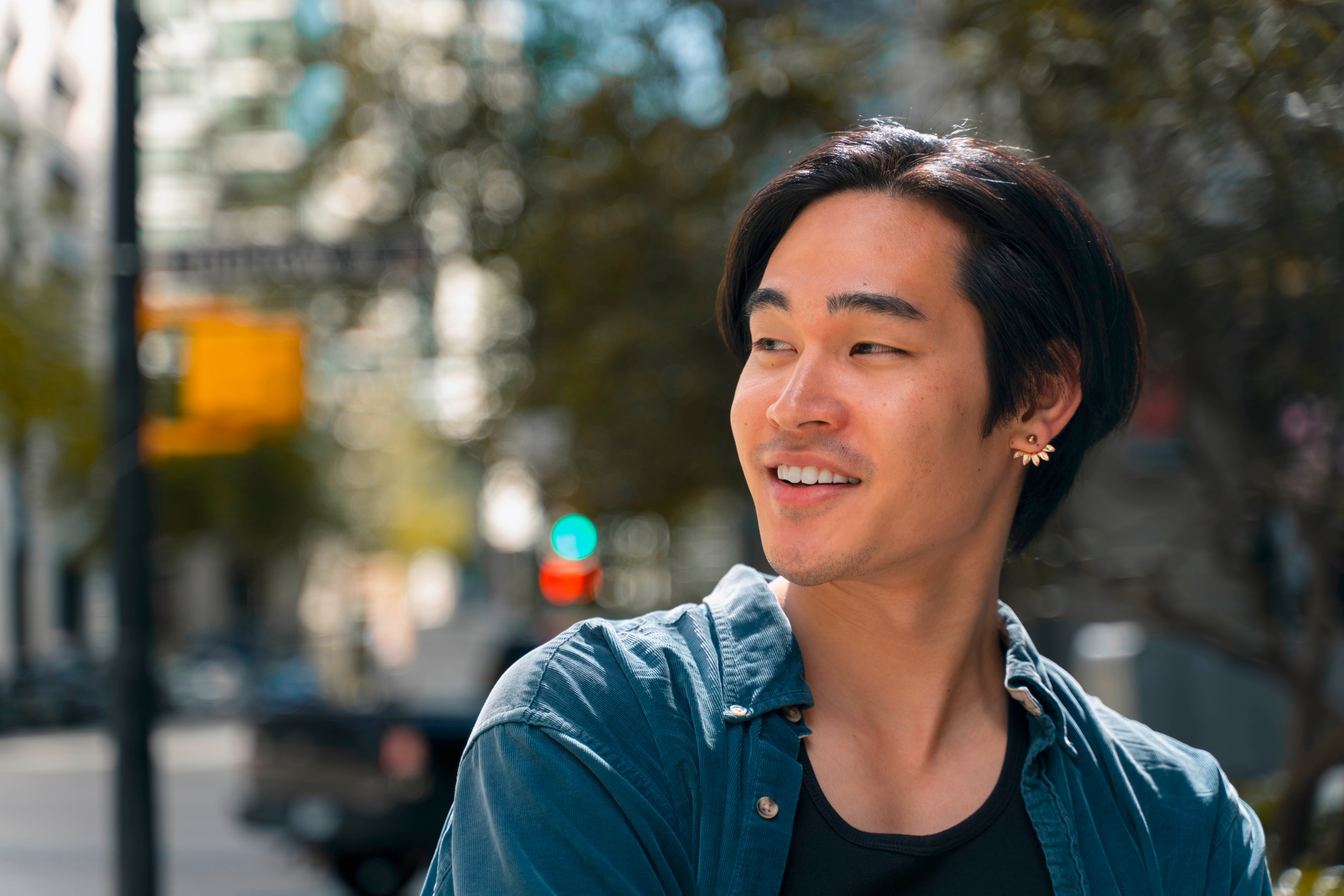A portrait of man looking away from the camera while walking down the street.