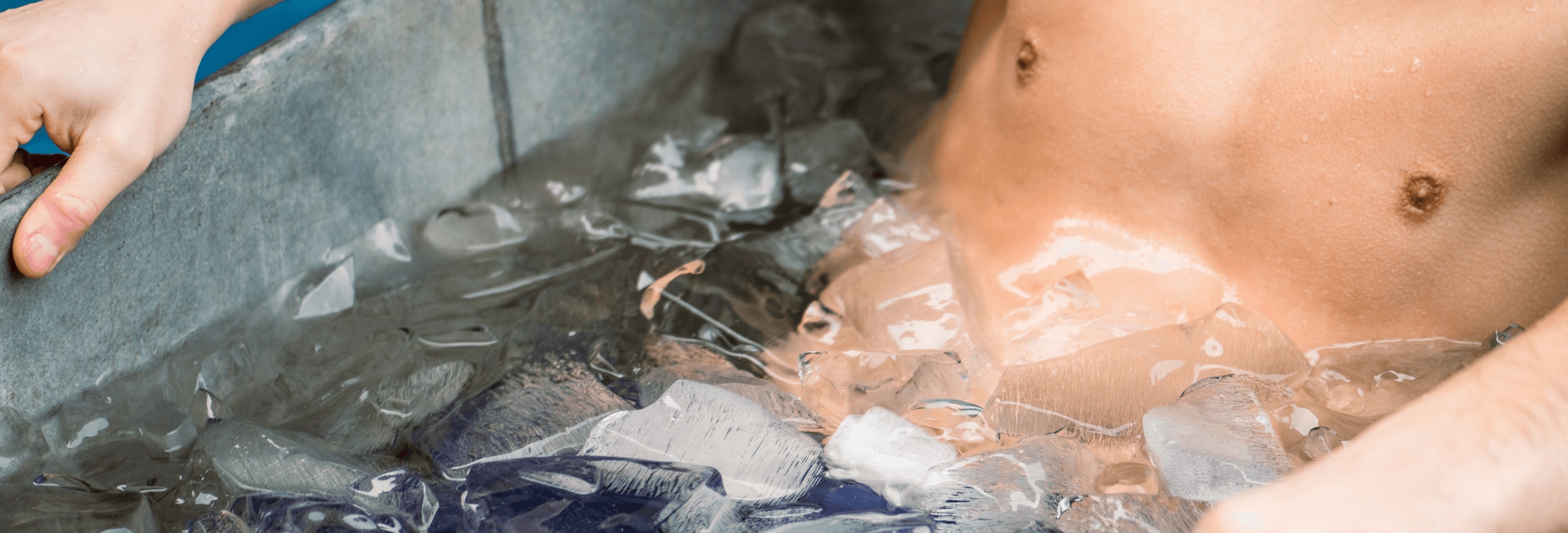 Man taking the plunge in an ice bath. 