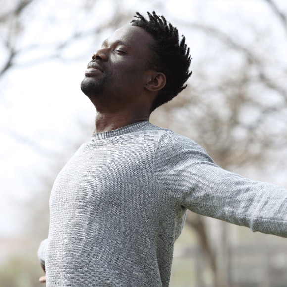 Man breathing in fresh air with no concerns of body odor because he used antibacterial deodorant.