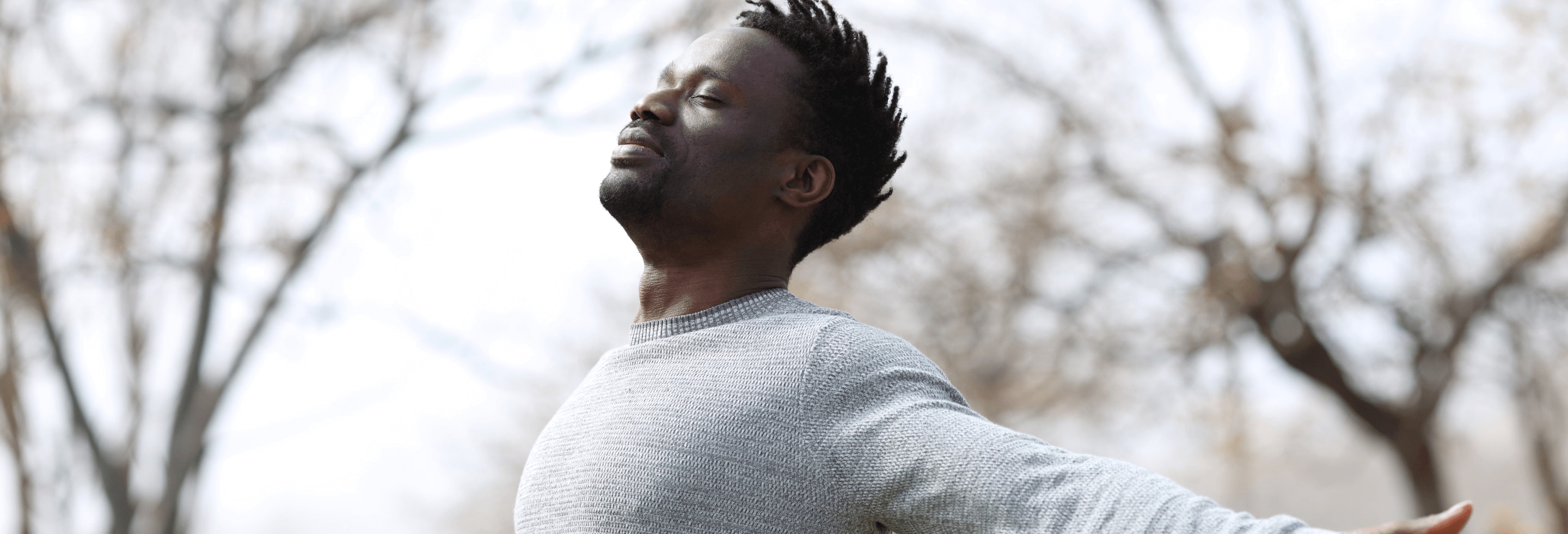 Man breathing in fresh air with no concerns of body odor because he used antibacterial deodorant.