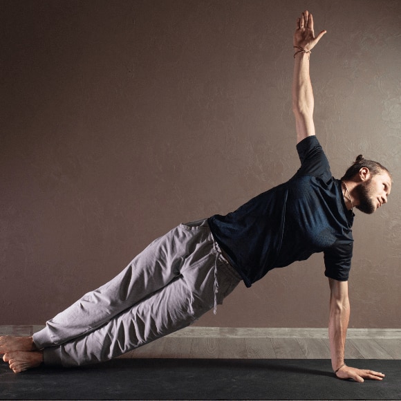 Young sporty man practicing yoga and staying fresh with whole body deodorant