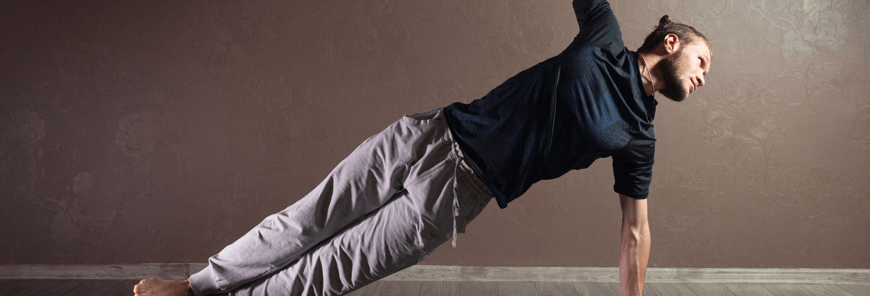 Young sporty man practicing yoga and staying fresh with whole body deodorant