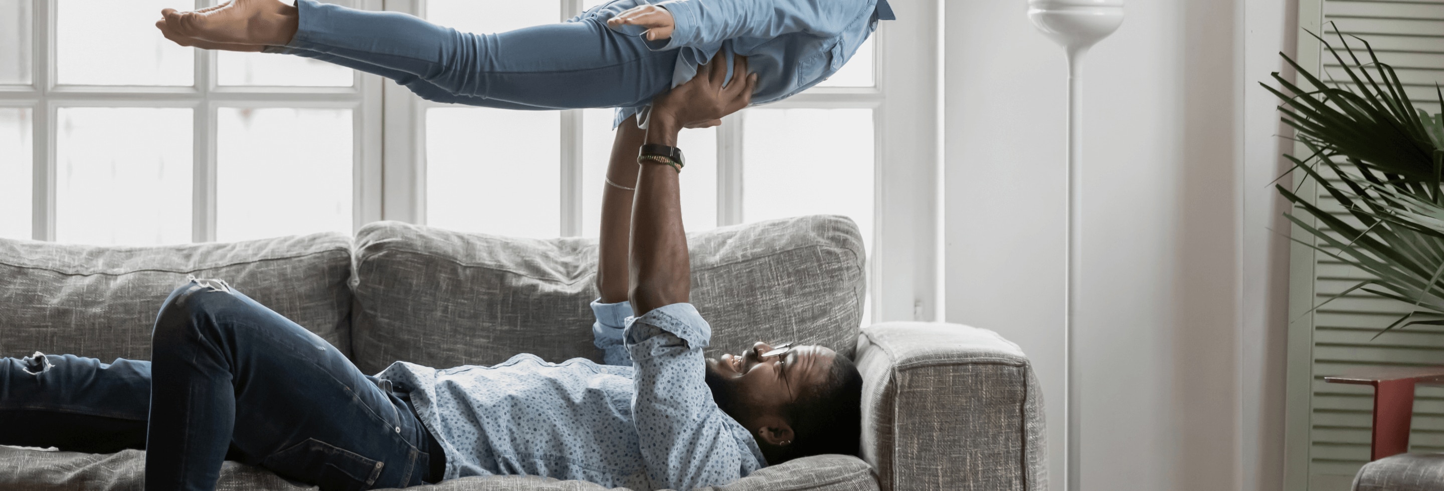 Happy strong father lifting his daughter and feeling confident after using alcohol-free deodorant