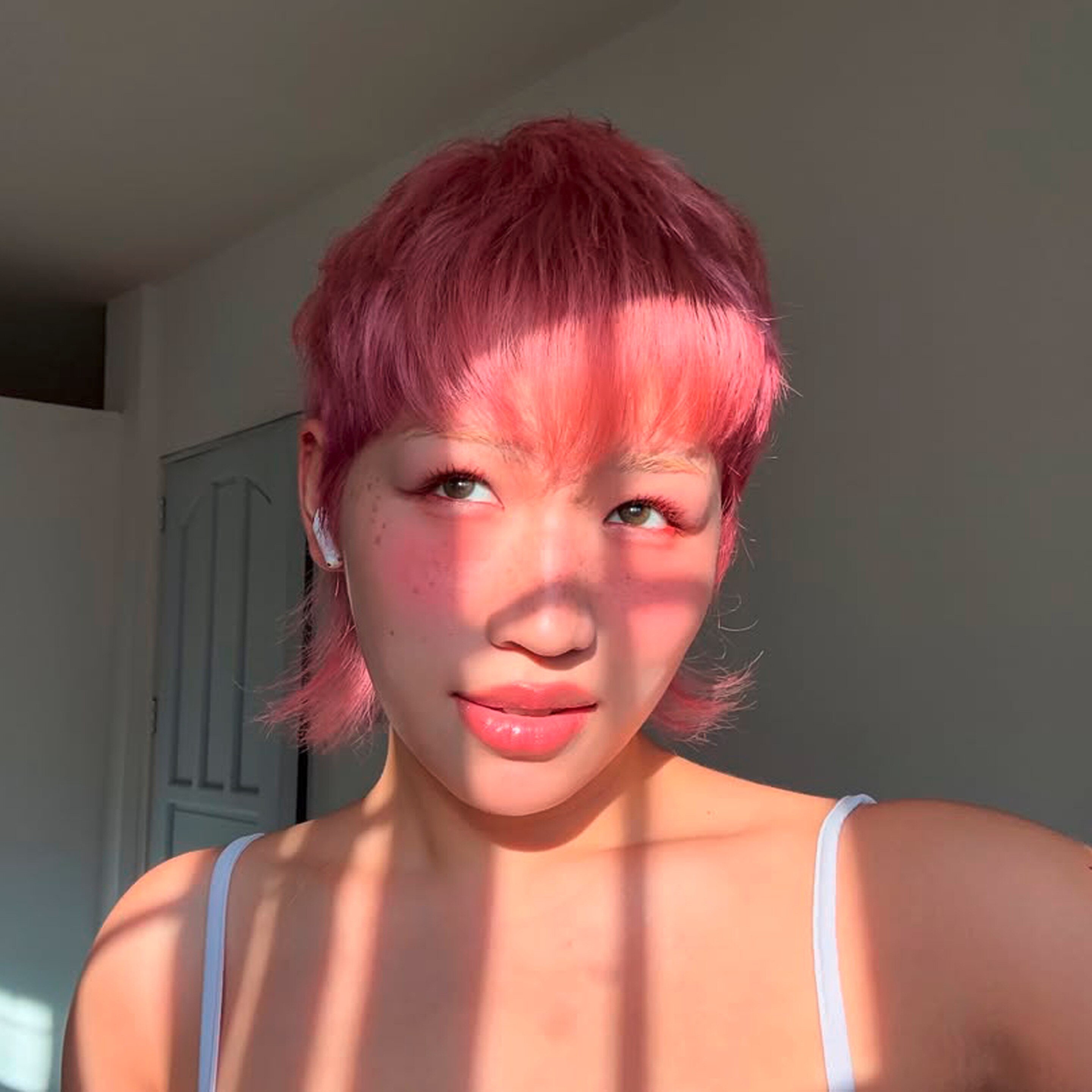 Beauty creator wearing pink makeup all over.