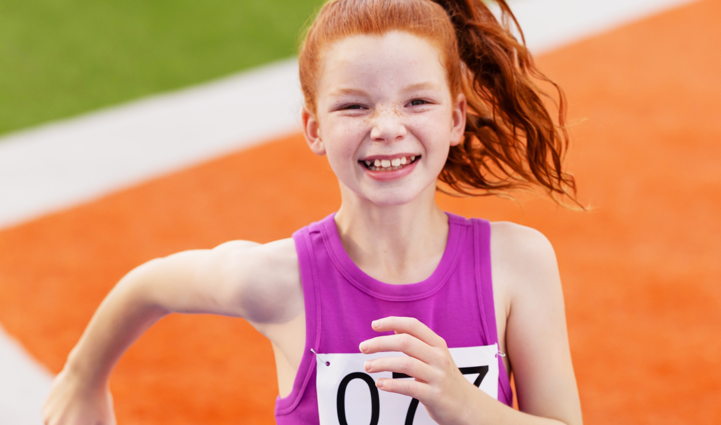 Girl smiling on track field