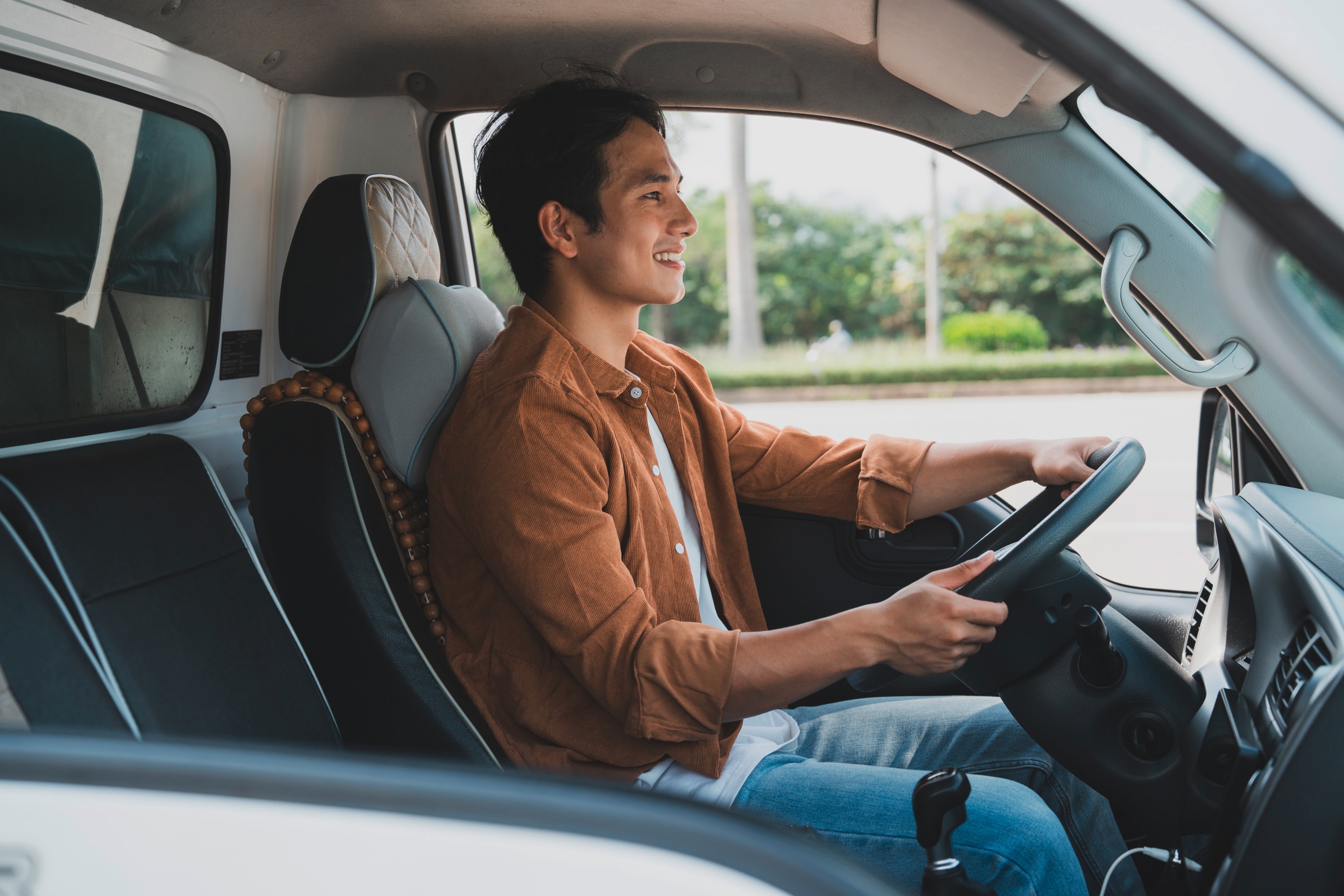 Man smiling while driving.