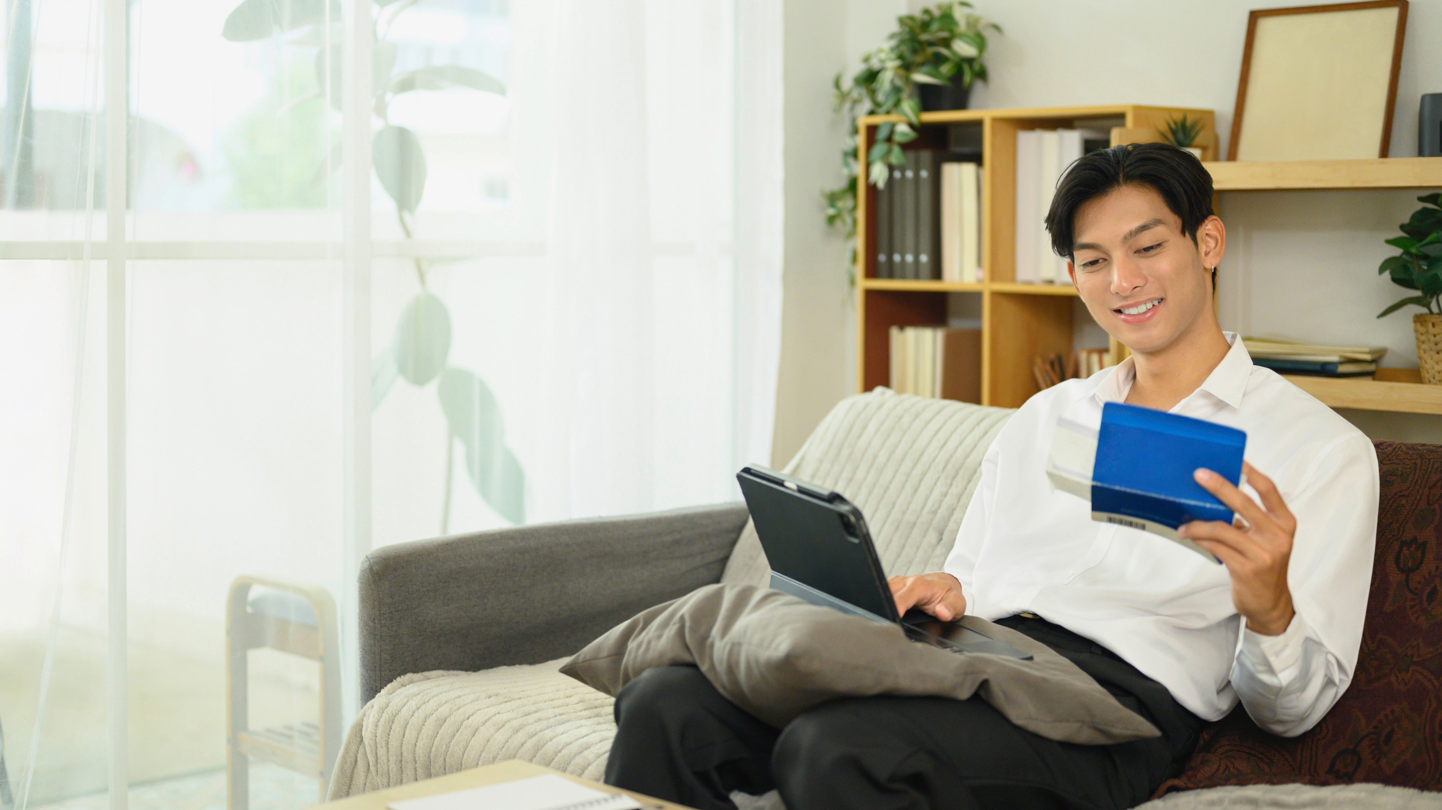 Asian man computing finances.