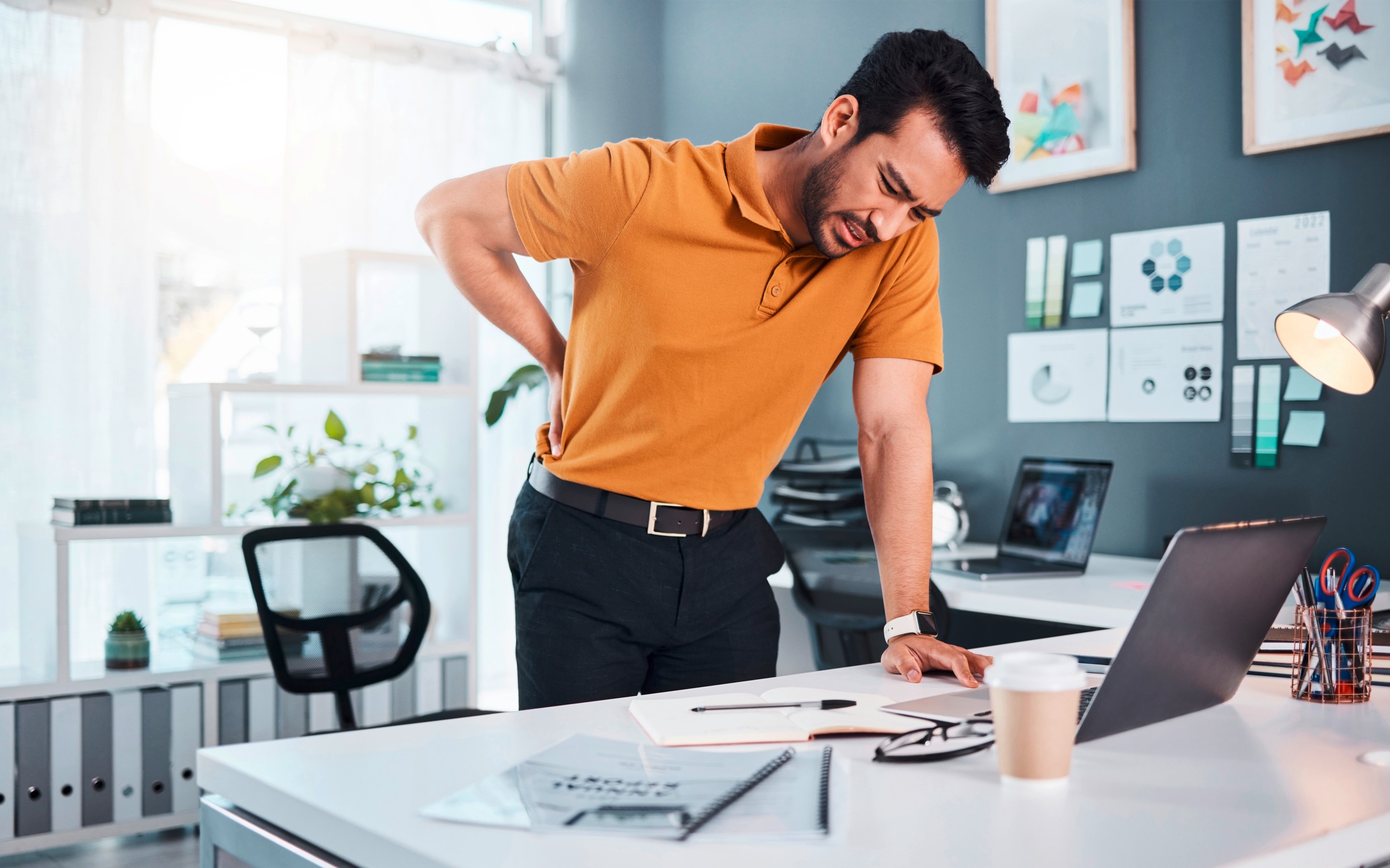 Man touching his lower back area in pain.
